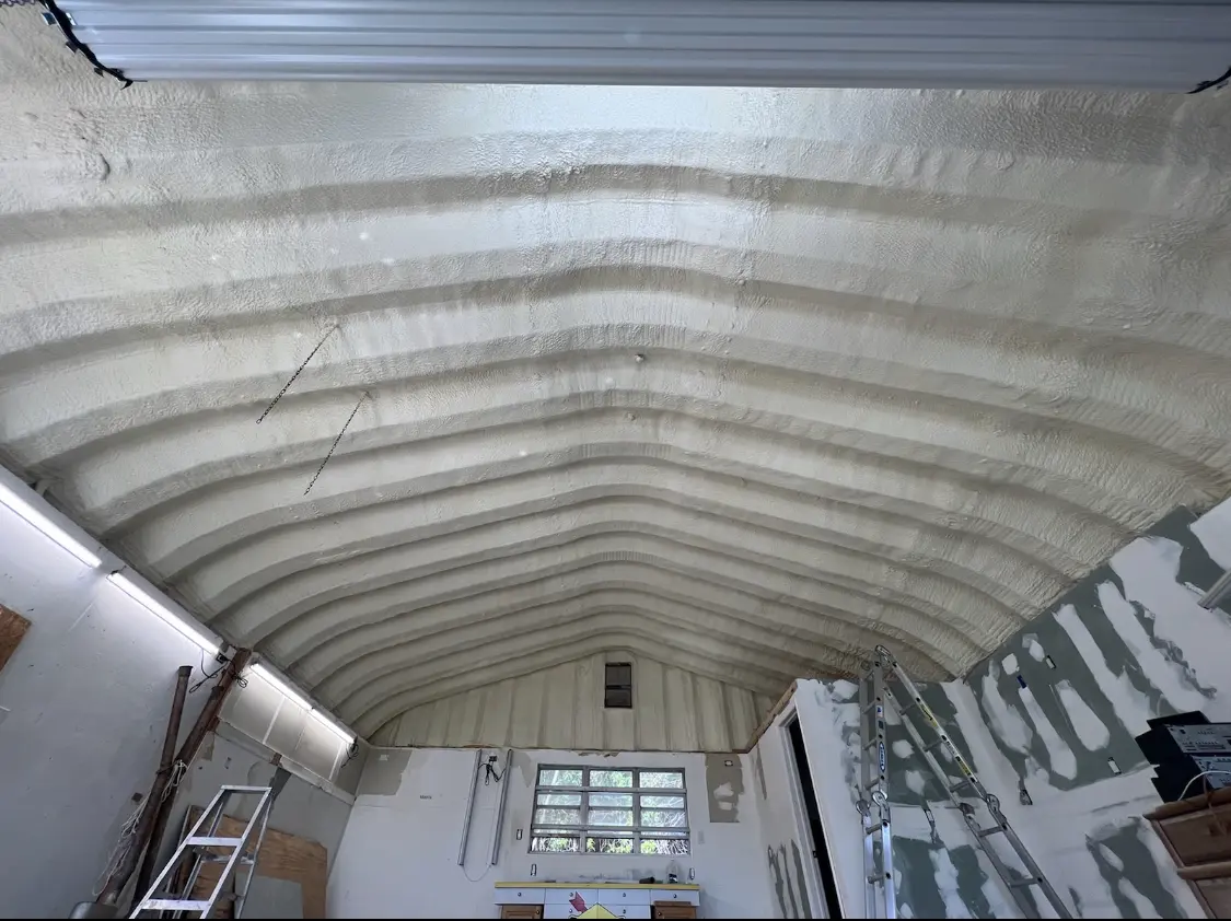 Spray polyurethane foam applied to the underside of a metal roof deck in Roanoke Rapids